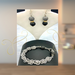 Agate stones of gray and black mixed with chain maille and a rhinestone-encrusted black toggle clasp. 